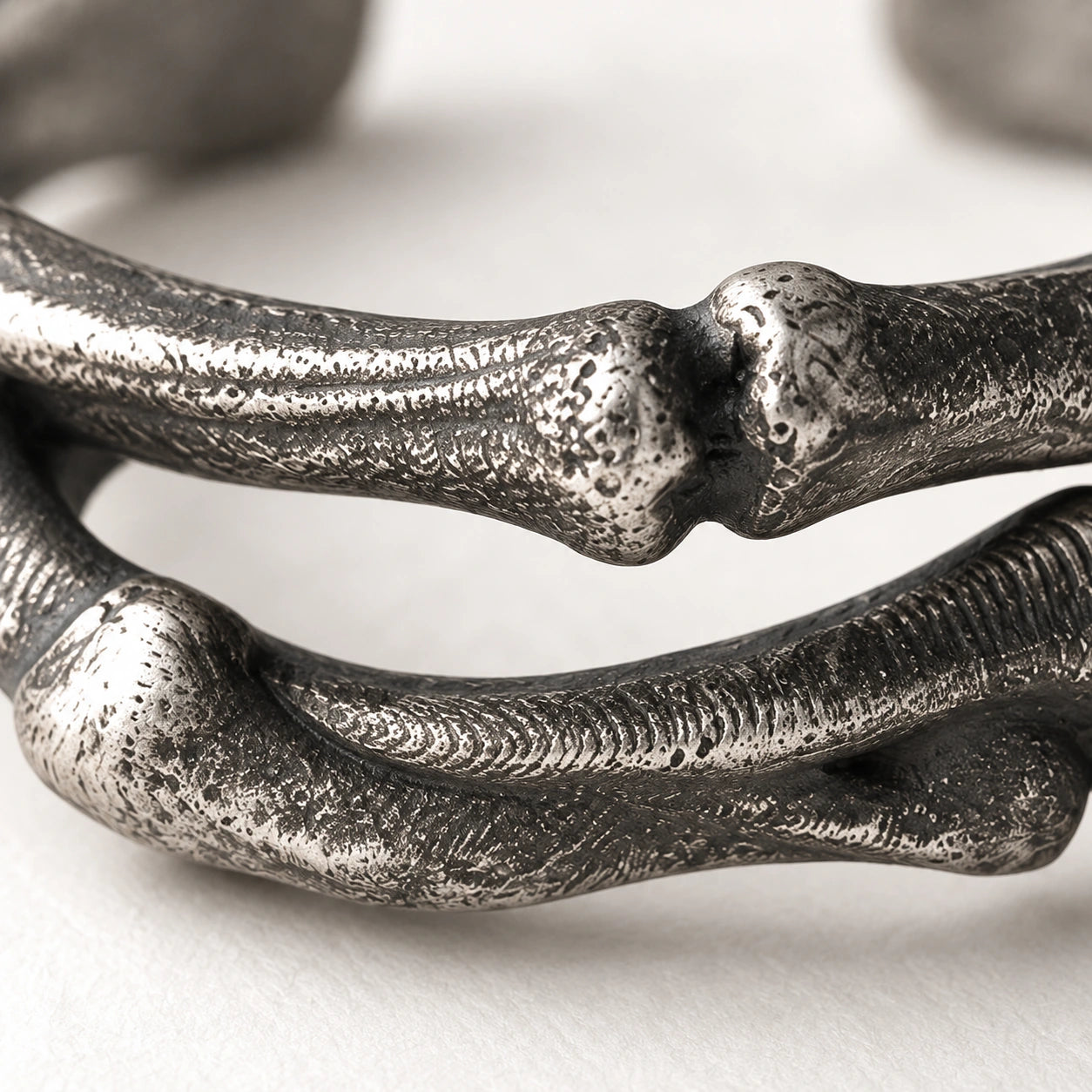 Close-up of the Bone Ring's rounded bone joints, textured silver and open spaces