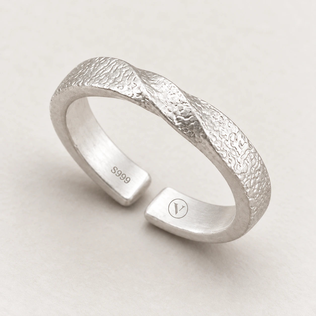 Silver Mobius ring with a textured twist and inner S999 and circle-V marks