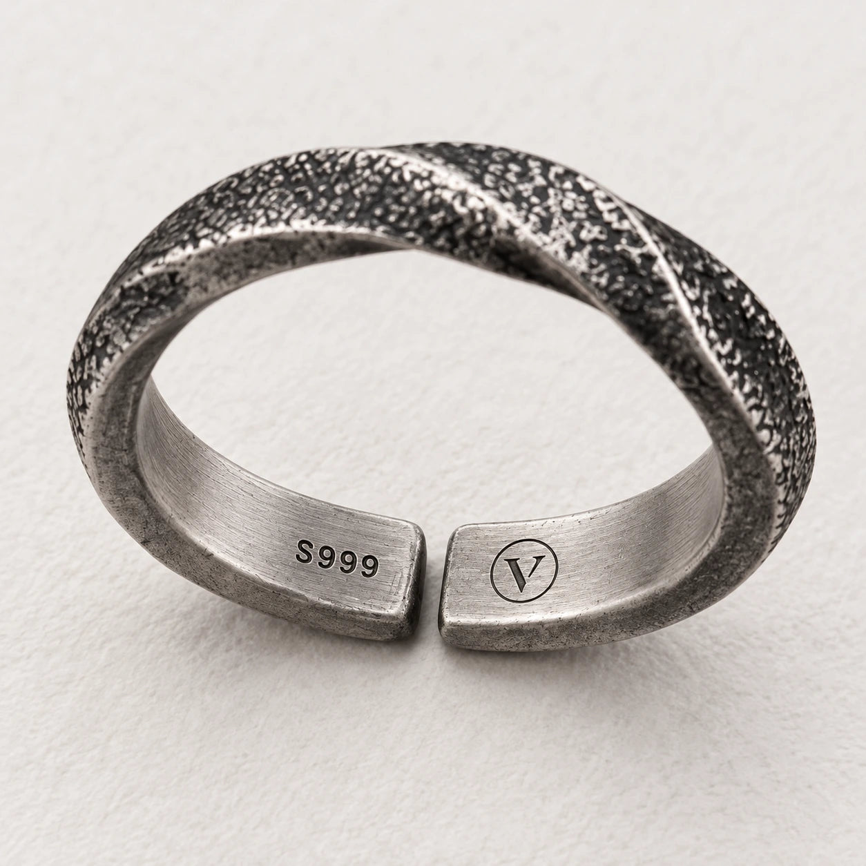 Inner S999 and circle-V marking design on separate ends of the open ring